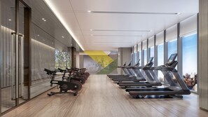 A gym with treadmills aligned along a wall with large windows, allowing natural light and views of the city. - Holiday Inn Xian East (Xi'an)