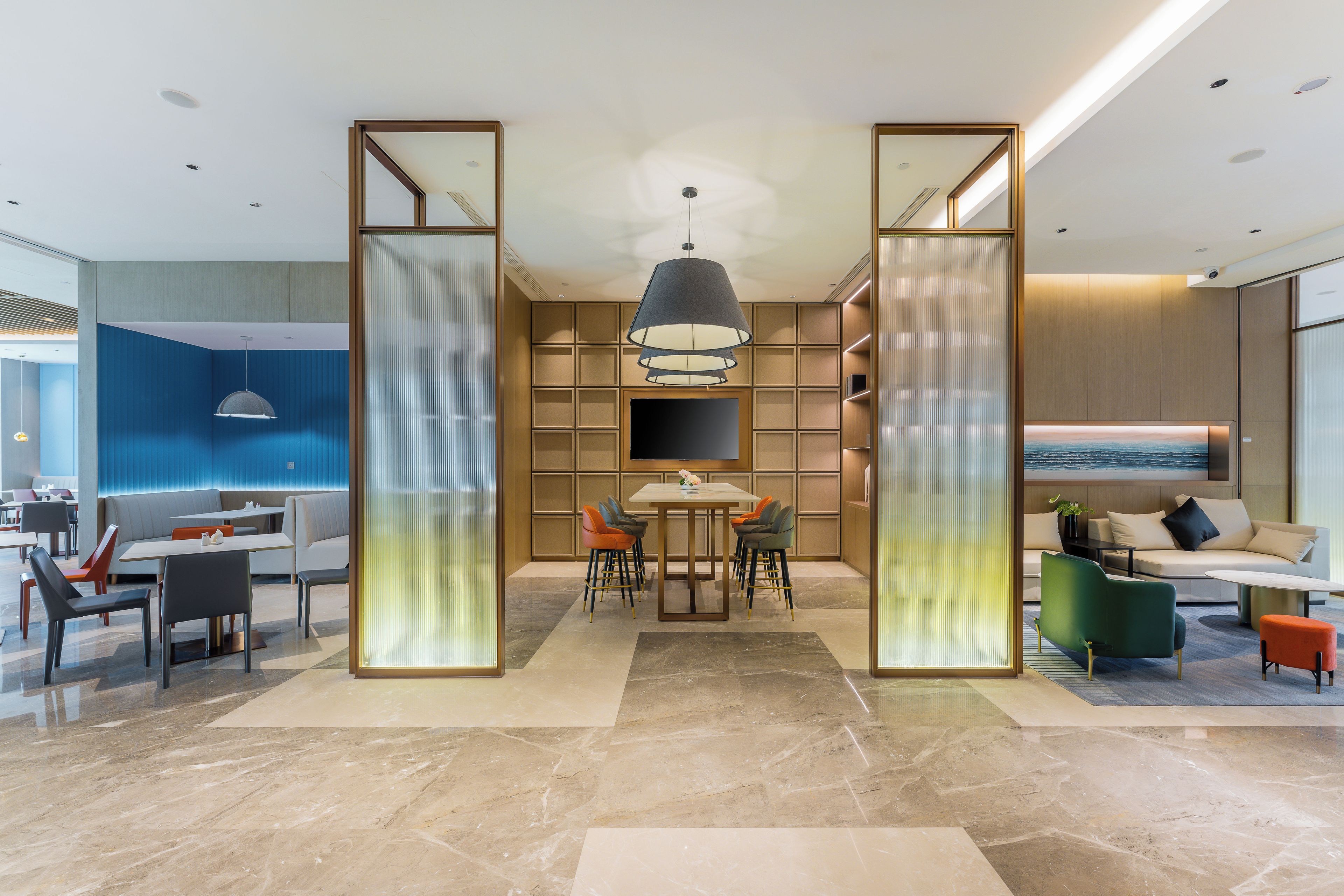 Un interior moderno con comedor, asientos y vista al mar.