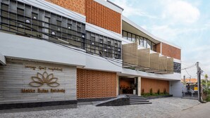 A modern building with a brick facade, large windows, and a sign reading "Mokko Suites Batubalang". - Mokko Suites Batubelig (Keroboken Kelod)