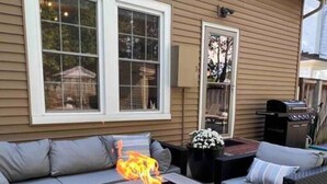 An outdoor patio with a fire pit, two sofas, and a grill. - Blue Moon Cottage: Historic Owensboro Home w/ Large Pool, Music Room, Location! (Owensboro)