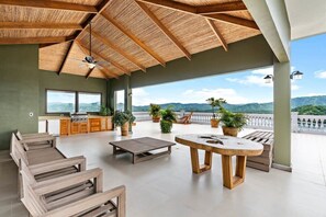 Outdoor dining - Luxury Condo with Panoramic Ocean Views, Sparkling Infinity Pool, and Modern Open-Concept Design (Playa Flamingo)