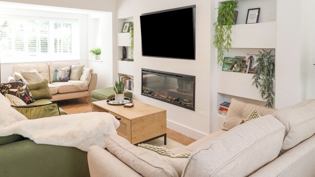 A modern living room with a sofa, coffee table, and fireplace. - Rydal Rock (Ambleside)