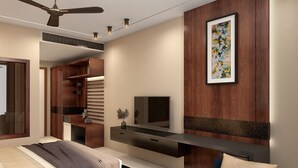 A modern bedroom with a bed, a TV, a desk, and a wardrobe. - Cygnett Inn  (Kishangarh)