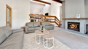 A modern living room with a fireplace, a sofa set, and a coffee table. - The Reserve Homestead walk to vineyards (Pokolbin)