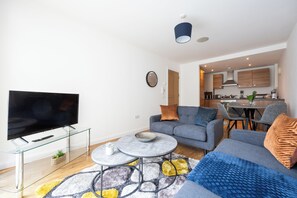 City Apartment | Living area | 32-inch Smart TV with cable channels, Netflix, streaming services - Convenient 2 Bedroom Apt With Parking (Manchester)