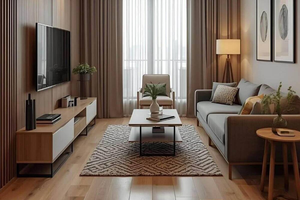 A modern living room with a flat-screen TV, a sofa, a coffee table, and a lamp.