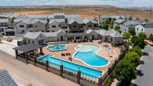 A residential complex with multiple houses, a swimming pool, and a covered patio area.
