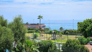 A beachside view with a fenced playground, a building labeled "MAX BEACH", and a clear view of the ocean. - Modern 2 bed apartment Riviera close to the beach (Mijas Costa)