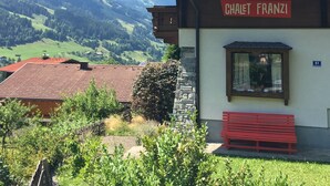 Un edificio con un letrero que dice "CHAEFT FRANZI" y una vista de montañas al fondo.