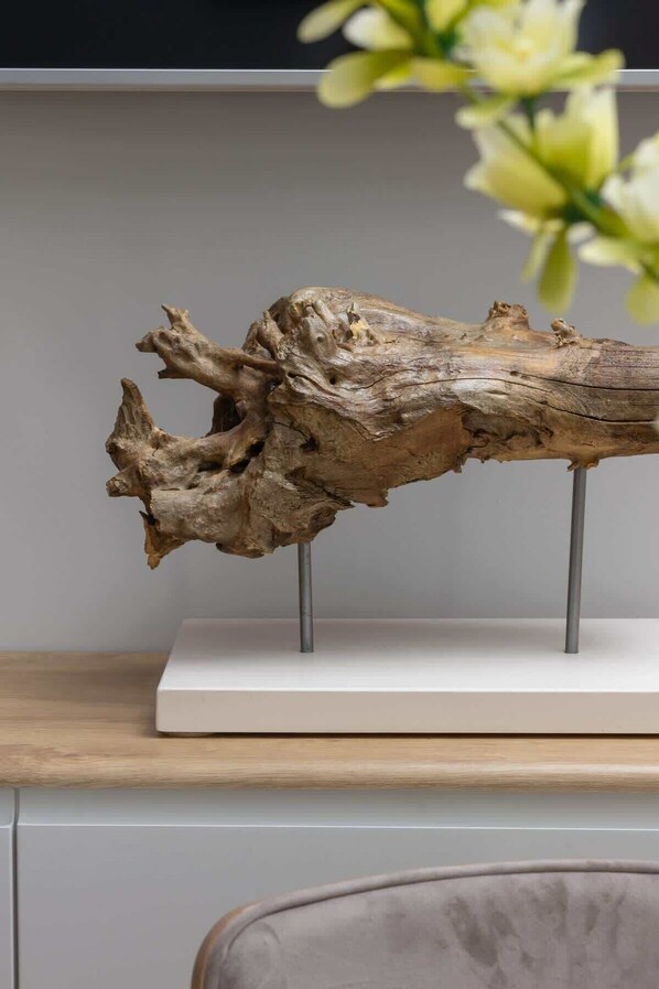 A piece of driftwood mounted on a stand.