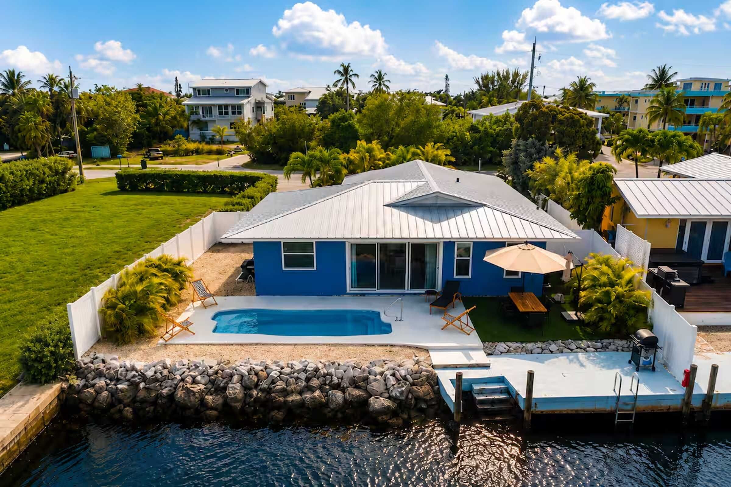 The backyard brings pool time, dock time, and canal mornings all within reach for an easy waterfront stay.
