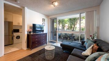 Basic Apartment, Multiple Beds | Living area | TV