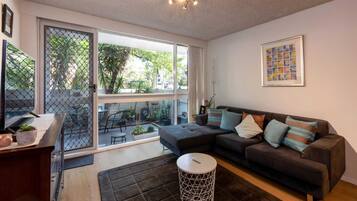 Basic Apartment, Multiple Beds | Living area | TV