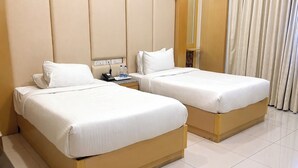 Two single beds with white linens in a hotel room. - AR Thanga Kottai (Tirupattur)