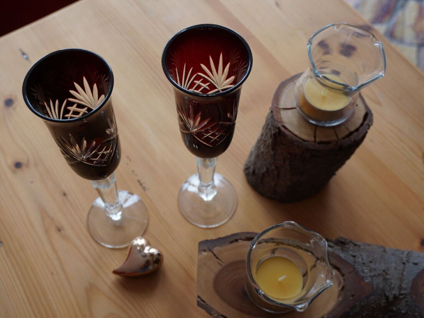 Tres vasos de un líquido oscuro, posiblemente vino, sobre una mesa de madera.