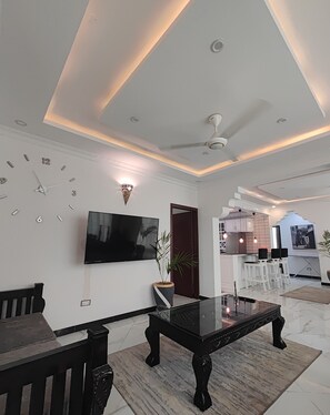 Standard Apartment, 3 Bedrooms, City View, Annex Building | Living area | 55-inch TV with digital channels - AYAA APARTMENT (Zanzibar Town)