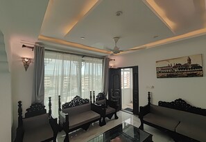 Standard Apartment, 3 Bedrooms, City View, Annex Building | Living area | 55-inch TV with digital channels - AYAA APARTMENT (Zanzibar Town)