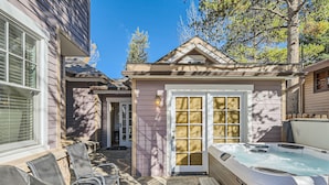 A backyard with a hot tub, patio furniture, and a covered seating area. - The French St Retreat 4 Bedroom Home by RedAwning (Breckenridge)