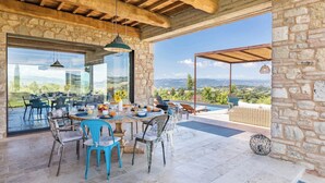 A dining area with a table set for breakfast, overlooking a scenic landscape. - Casale The Place 6+2, Emma Villas (San Damiano)
