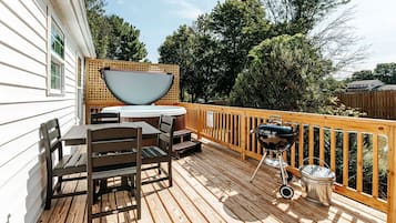 Enjoy al fresco dining on the deck with a round table and grill.