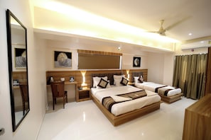 A modern hotel room with two beds, a desk, and a chair. - HOTEL ALFA EXECUTIVE (Mumbai)