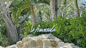 A rocky landscape with a sign reading "La Peninsula." - Special Savings January 2024 31 days minimum! (Naples)