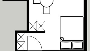 Ein Grundriss mit Küche, Essbereich und einem großzügigen Schlafzimmer.