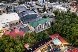 An aerial view of a hotel with multiple buildings, parking areas, and surrounding greenery. - Downtown Gatlinburg Condo | Walk to Attractions! (Gatlinburg)
