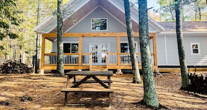 Dog-friendly, lakefront getaway with a firepit, dock, washer/dryer, & AC