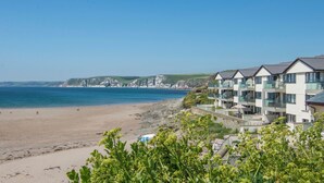 A coastal hotel with multiple balconies overlooking the beach and cliffs. - 14 Burgh Island Causeway (Kingsbridge)