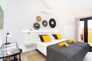A modern hotel room with a bed, bedside table, lamp, and wall decor. - Home2Book Modern Design Seaview Apt, Pool&Terrace (Playa de la Américas)
