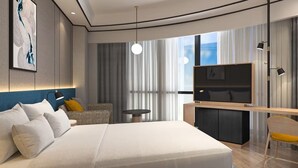 A modern hotel room with a large bed, a desk with a TV, a chair, and a view of the city through large windows. - Hilton Garden Inn Xiamen Tong'an (Xiamen)