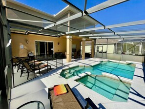 A rooftop pool area with a glass enclosure, lounge chairs, and a barbecue setup. - Suffolk Place (Davenport)