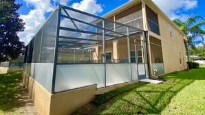 A modern building with a large glass enclosure, a flat roof, and a beige exterior. - Suffolk Place (Davenport)