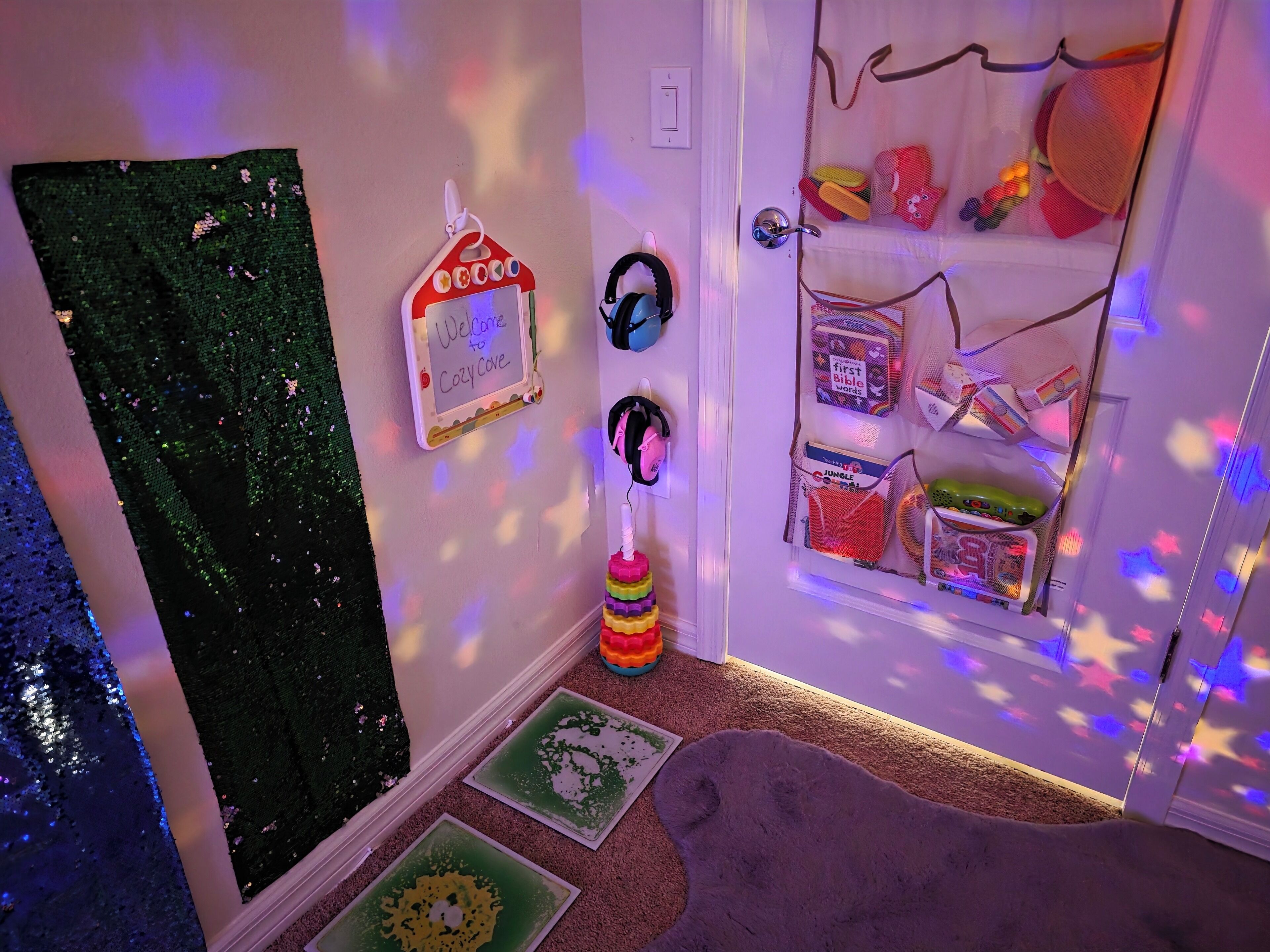 A child's room with a 'Welcome to Cozy Cave' sign, educational toys, and a bookshelf.