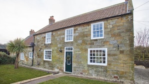 A stone house with a tiled roof, a green door, and multiple windows. - Host Stay Middle Farmhouse (Whitby)