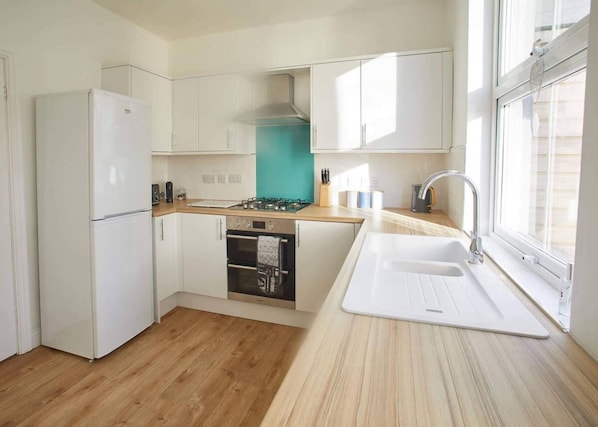 Enjoy cooking in this well-lit kitchen with a central island and stove and oven.