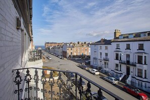 Residents enjoy a quiet neighborhood view from their balcony.