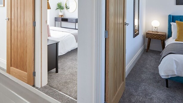 A bedroom with a bed, bedside table, lamp, and a wall-mounted picture. - Host Stay Montrose View (Saltburn-by-the-Sea)