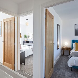 A bedroom with a bed, bedside table, lamp, and a wall-mounted picture. - Host Stay Montrose View (Saltburn-by-the-Sea)