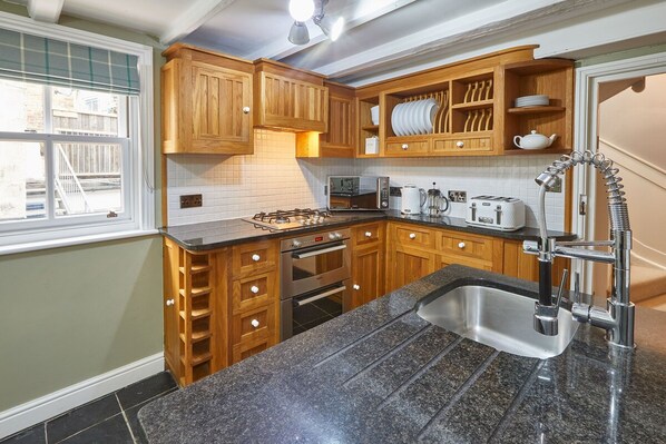 Enjoy cooking in this well-equipped kitchen with an oven, microwave, and toaster.