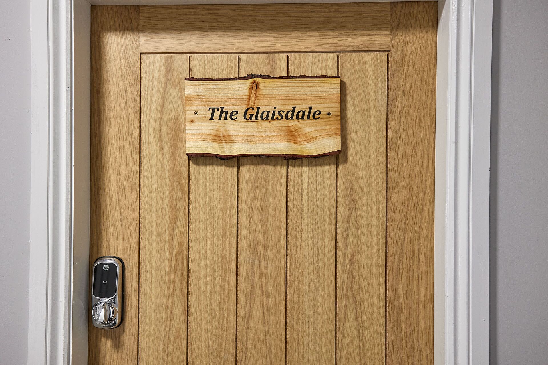 A wooden door with a sign that reads "The Glaisdale."