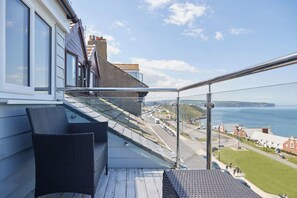 A balcony with a view of the sea and a road. - Host Stay Pier View Penthouse (Whitby)