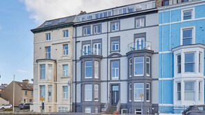 A row of terraced houses with bay windows and a corner bay window.