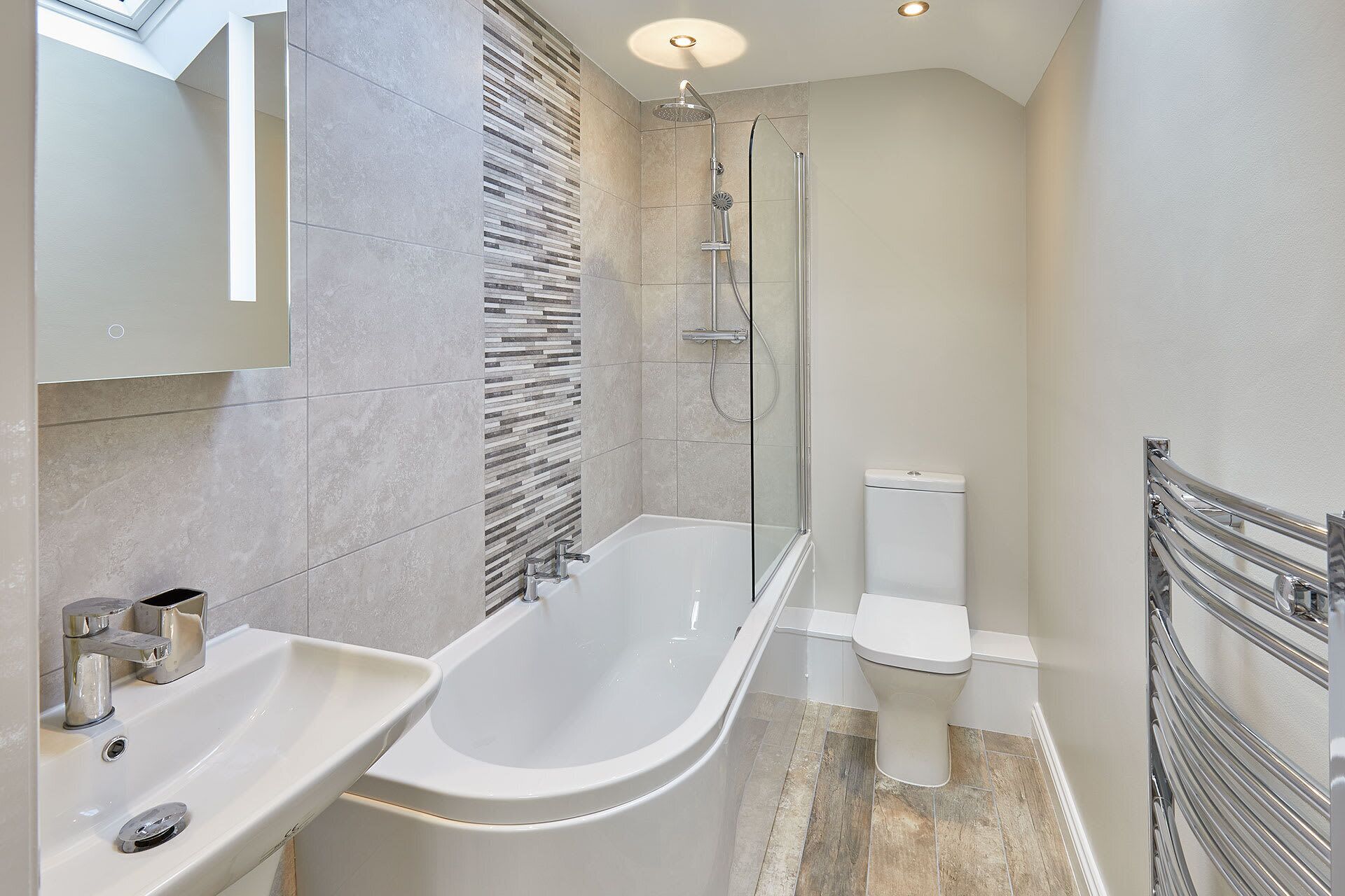 A modern bathroom with a freestanding bathtub, a glass-enclosed shower, and a toilet.