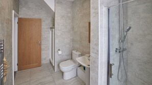 A modern bathroom with a shower, toilet, and sink. - Host Stay The Runswick at Brunswick Holiday Apartments (Whitby)