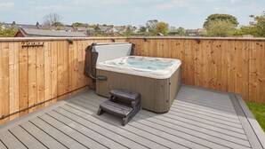 A hot tub on a wooden deck with a wooden fence in the background. - Host Stay Badgers Cottage (Saltburn-by-the-Sea)