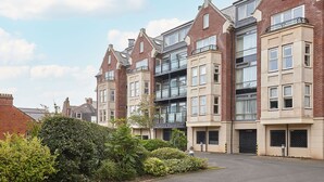 A row of modern apartment buildings with multiple floors, large windows, and balconies. - Host Stay Turnstones Apartment (Whitby)