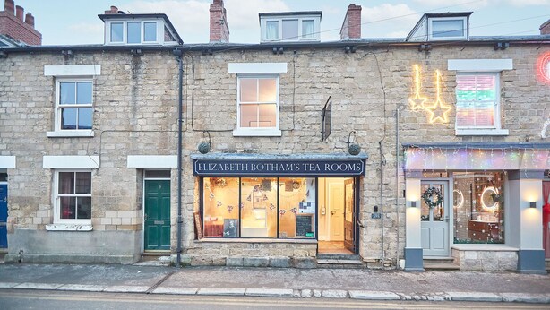 A two-story stone building with a tea room named "Elizabeth Rotham's Tea Rooms" on the ground floor. - Host Stay Sleepers No 8 (Pickering)