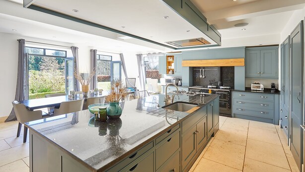 A modern kitchen with a large island, built-in appliances, and ample storage. - Host Stay The Lakehouse (Whitby)